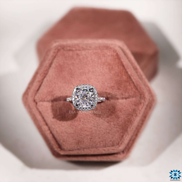 Pave setting ring with cushion cut center stone.
