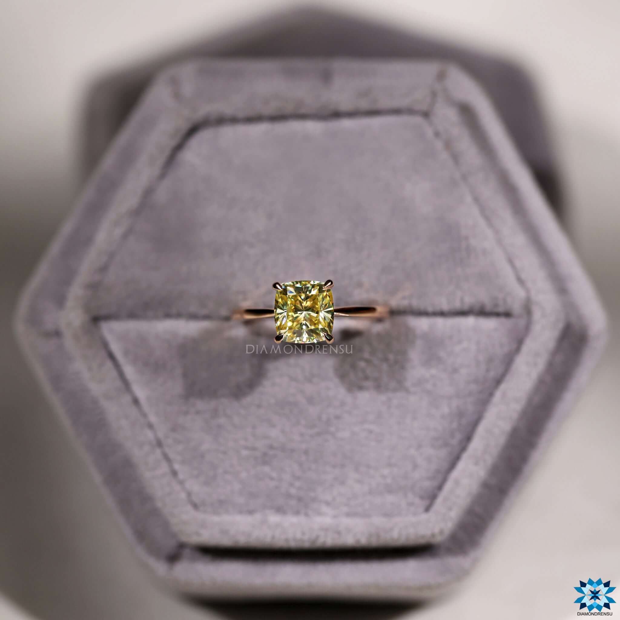 4 prong claw setting holding yellow moissanite.