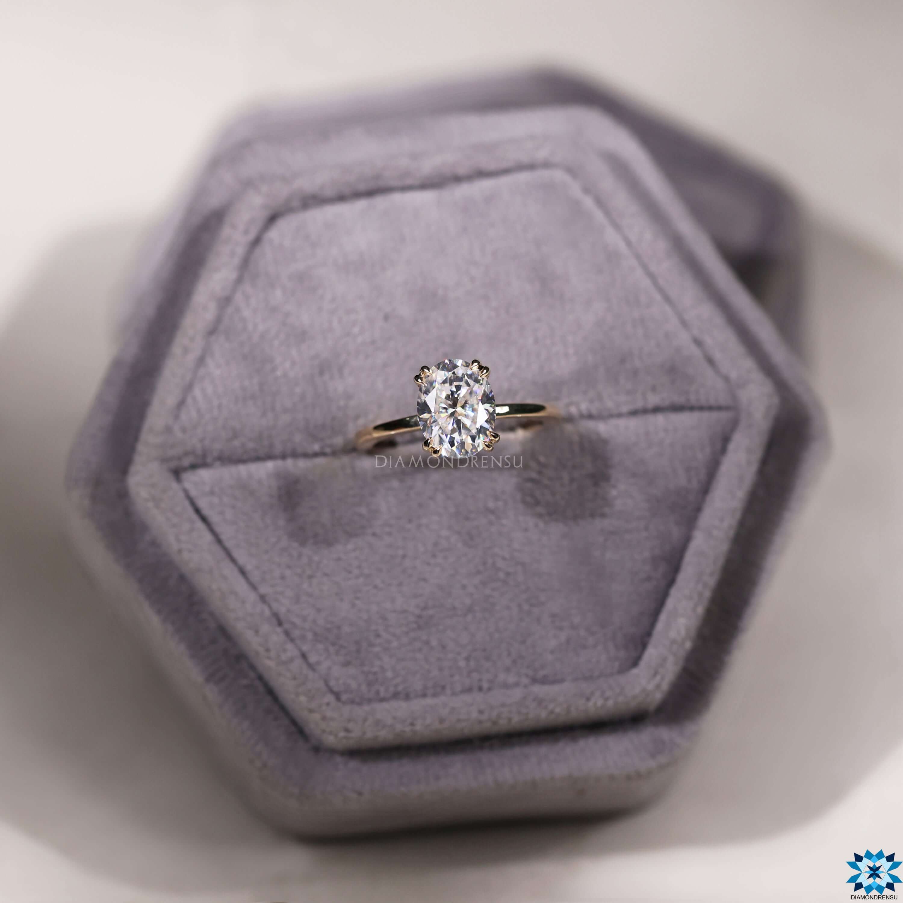 Double claw prong setting oval moissanite ring.