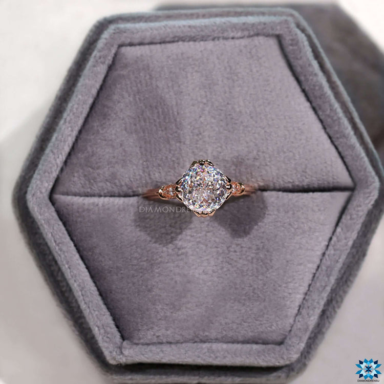 Moissanite ring with fishtail prong and milgrain setting.