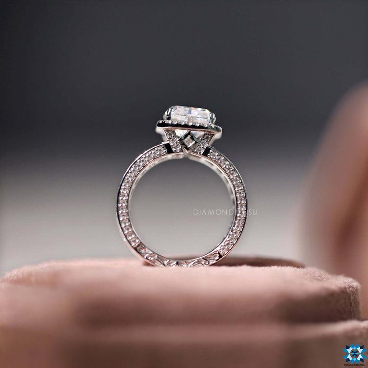 Princess cut hidden moissanite accents in halo setting.