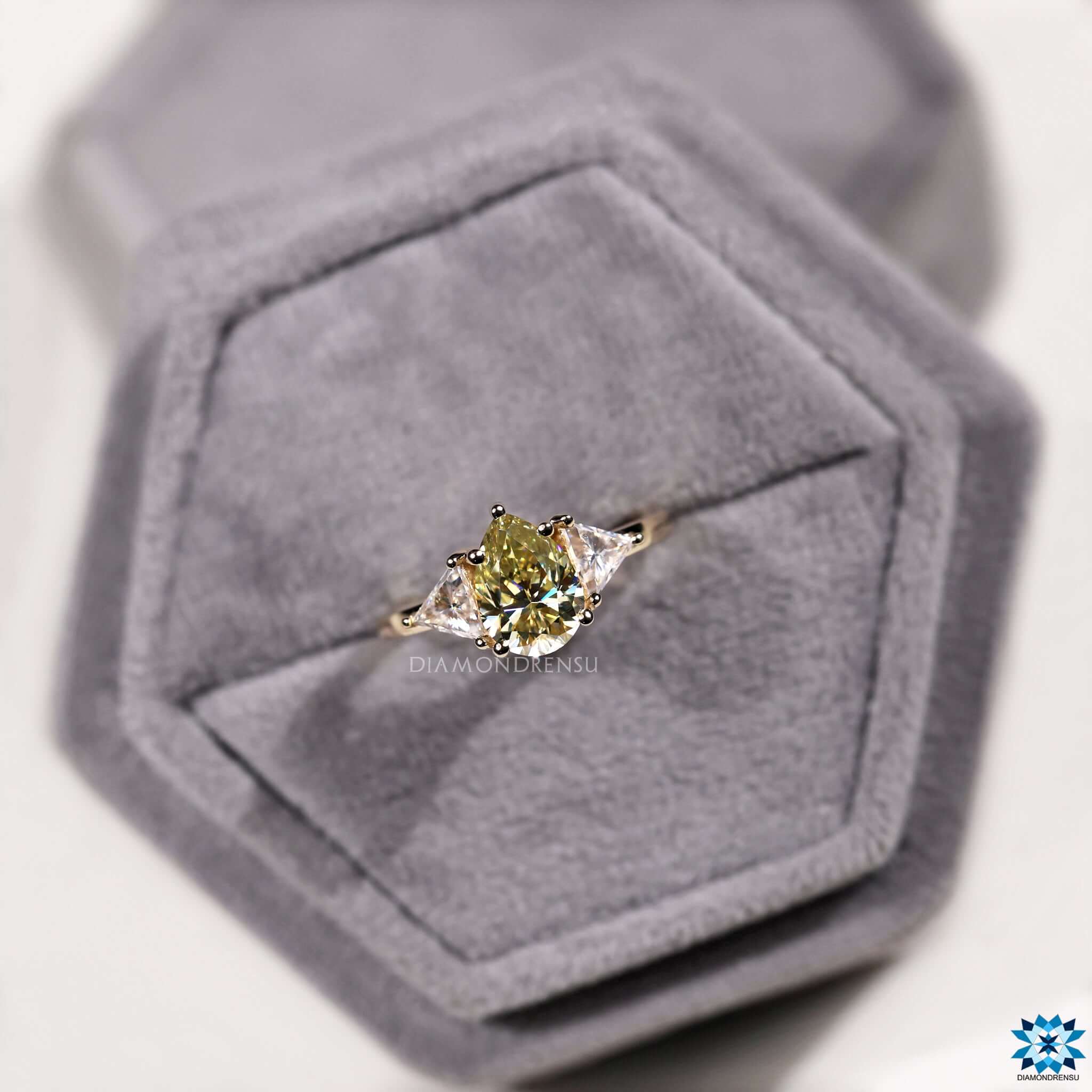 Yellow moissanite ring with stunning pear shaped centre stone.