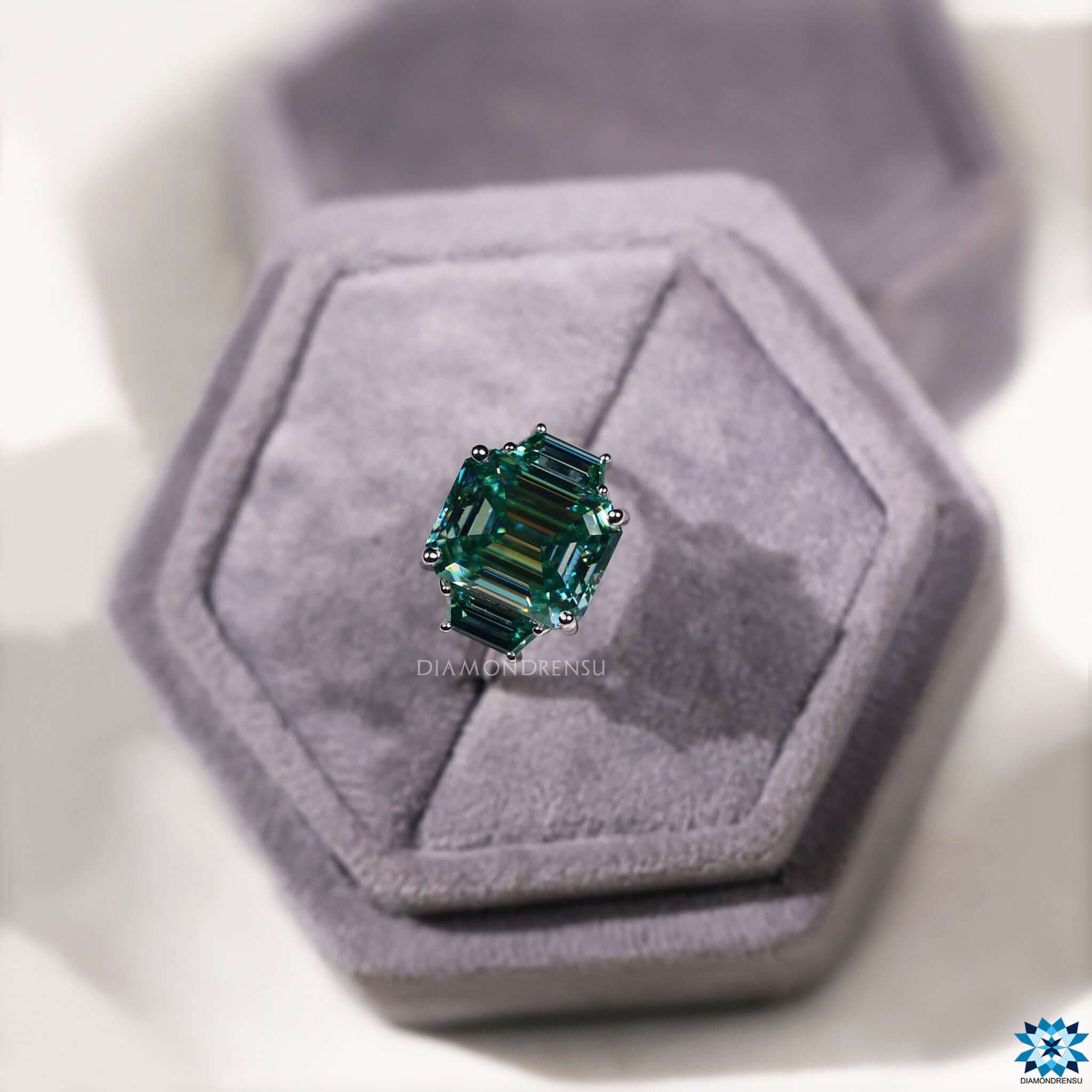 Handmade three stone ring with cyan blue moissanite.