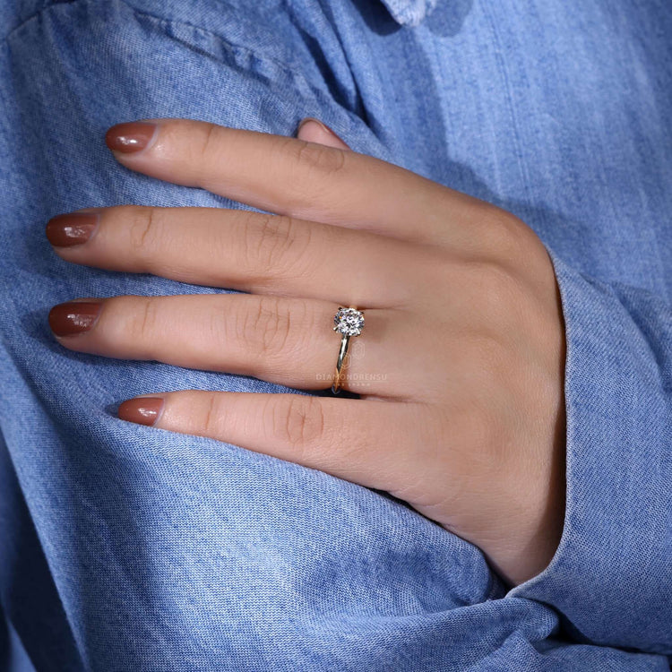 Knife edge ring with a solitaire round engagement ring design, igi certified for quality and brilliance.