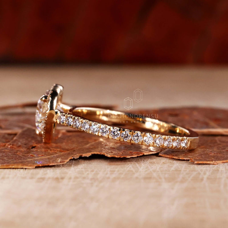 Heart shaped halo ring with pave diamond accents and a claw prong setting for sophisticated charm.