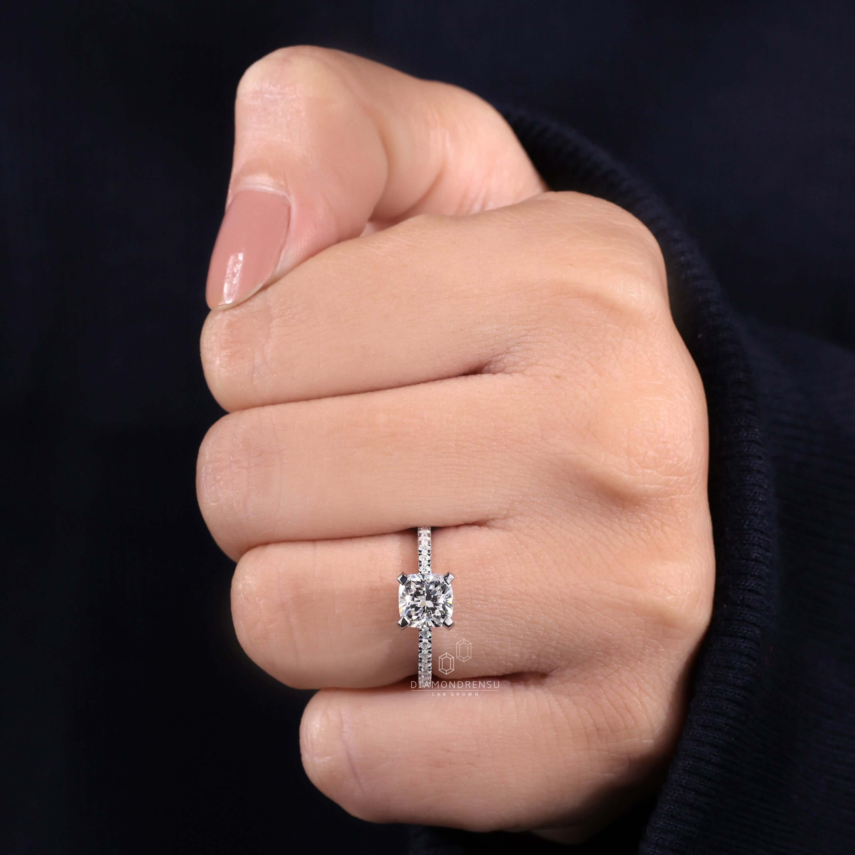 Engagement ring with pave accents and cushion cut diamond brilliance.