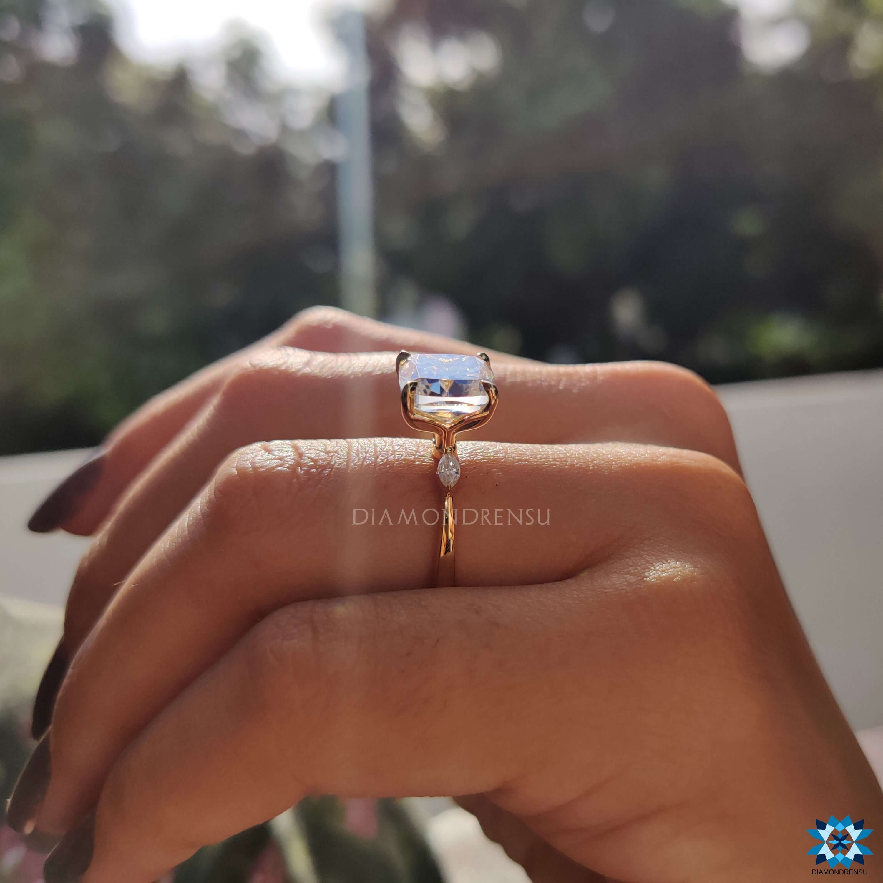 Handmade jewellery featuring a cushion cut and two pear moissanite stones.