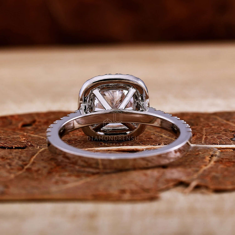 White gold engagement ring with a cushion diamond ring centrepiece.