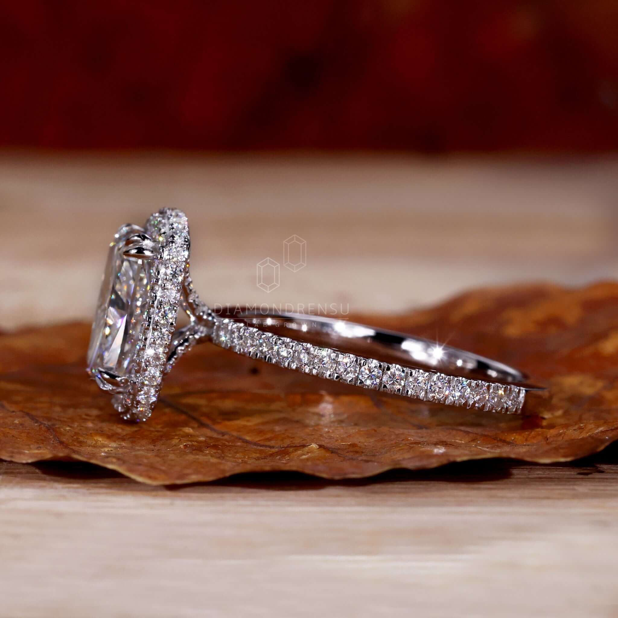 Cushion diamond ring with elongated cushion cut diamond and halo ring setting for women.