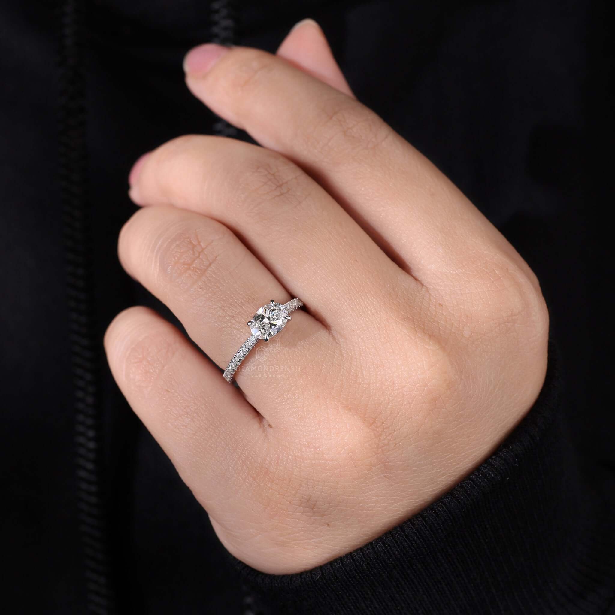 Oval diamond ring paired with a shared prong eternity band