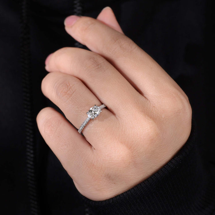 Oval diamond ring paired with a shared prong eternity band