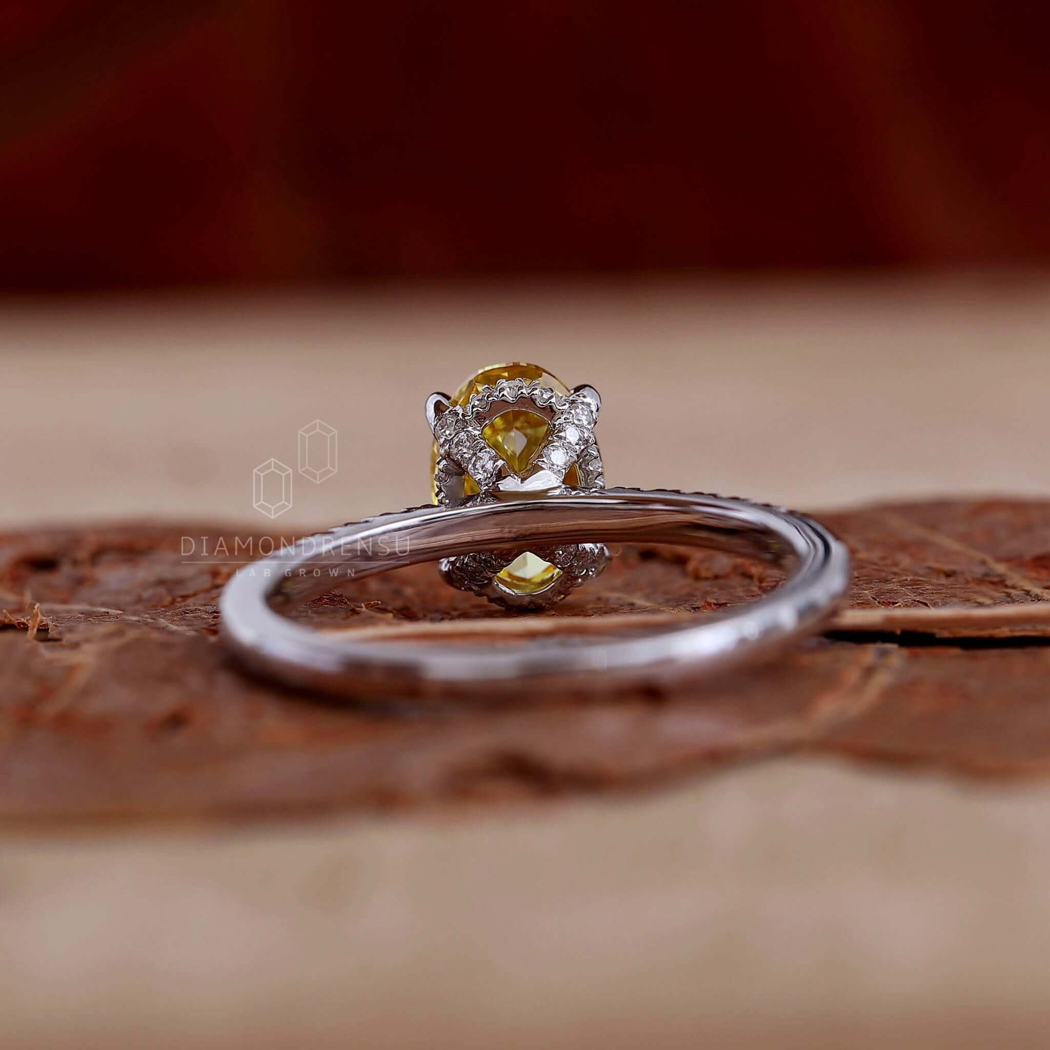 Oval diamond ring showcasing yellow diamonds in a handmade jewelry style perfect for engagements.