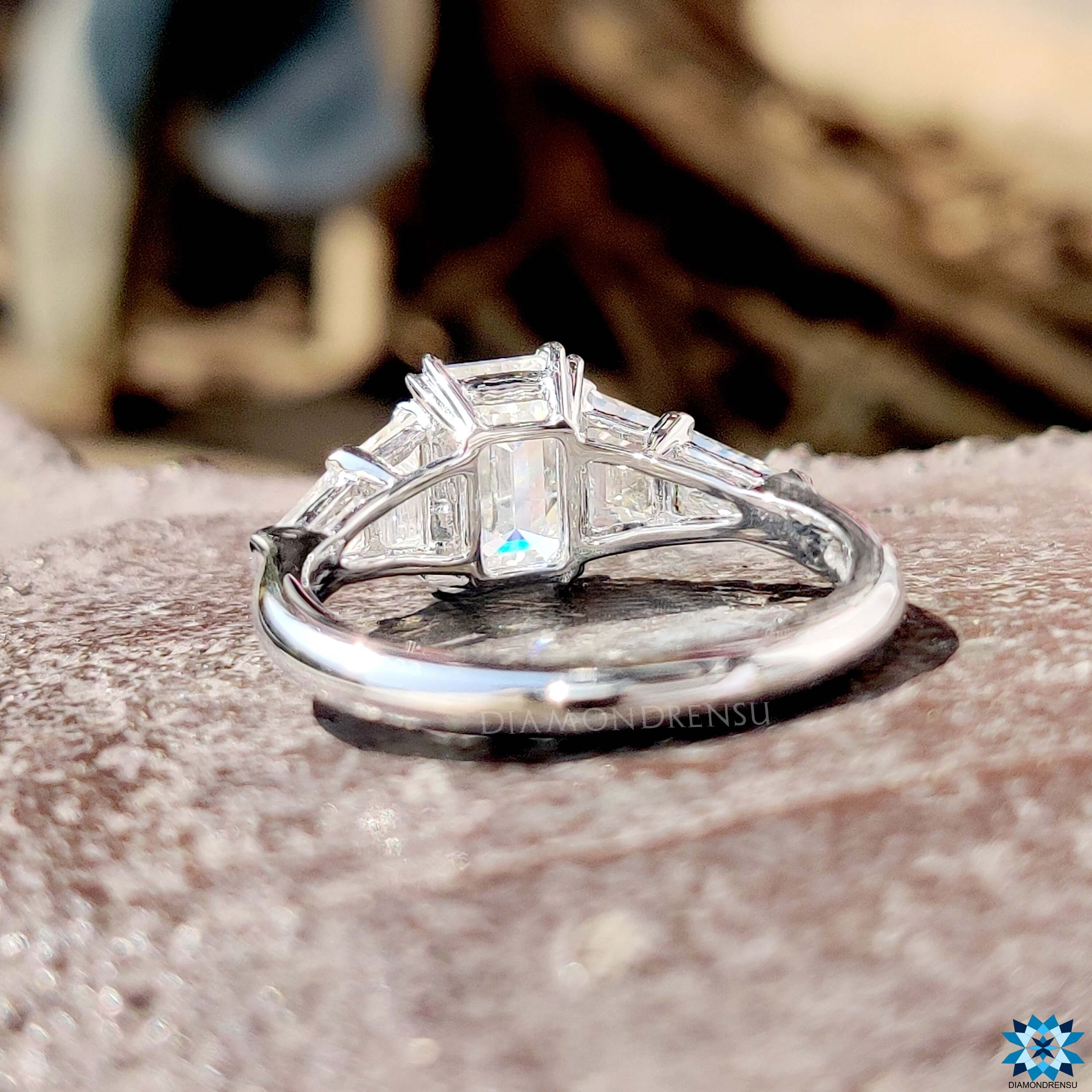 Custom emerald and trapezoid cut moissanite ring.