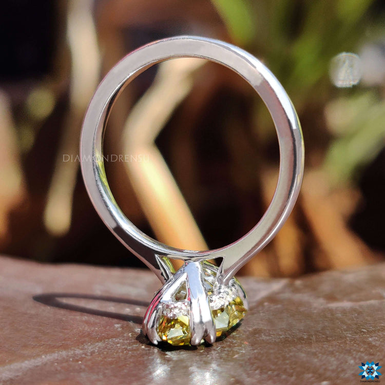 Solitaire setting ring with a vibrant yellow center.