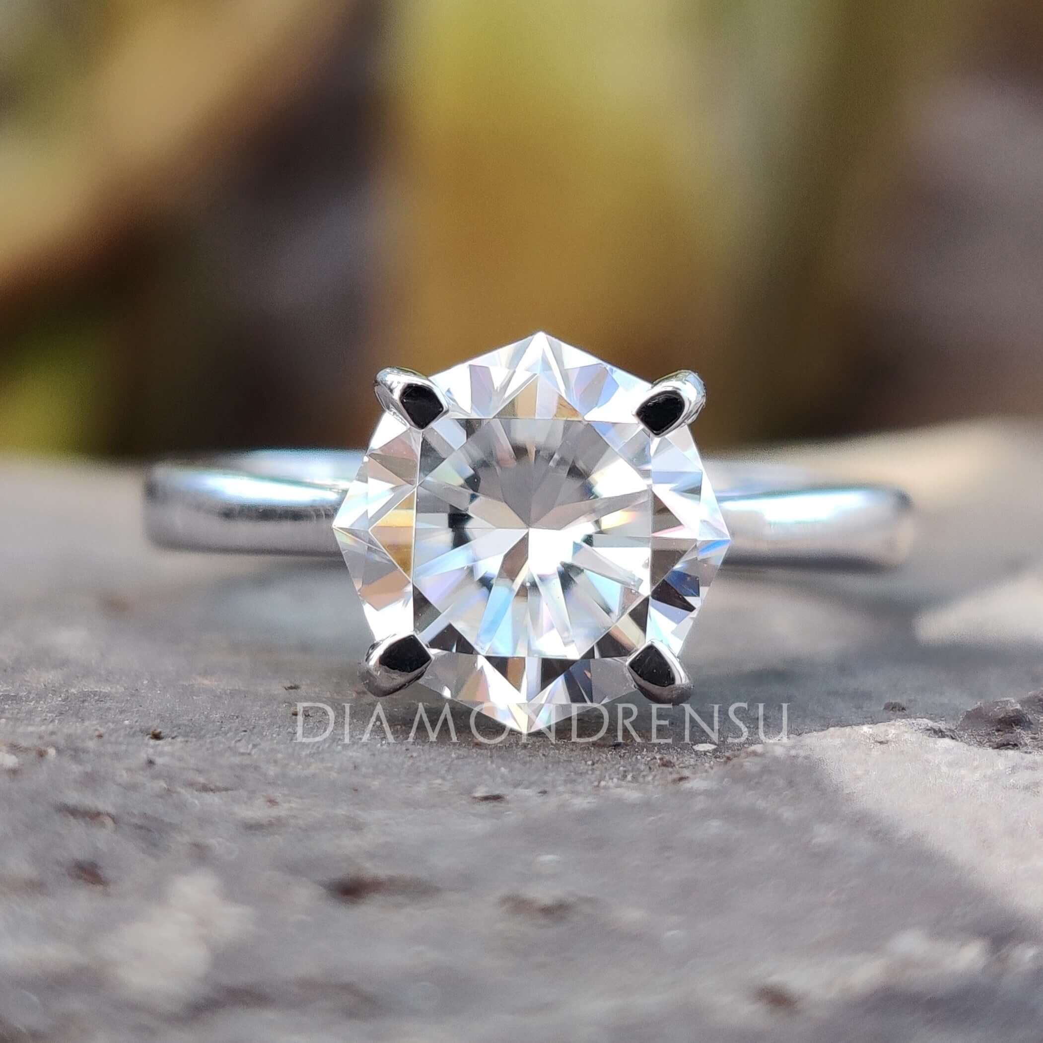Octagon cut moissanite solitaire ring in white gold.