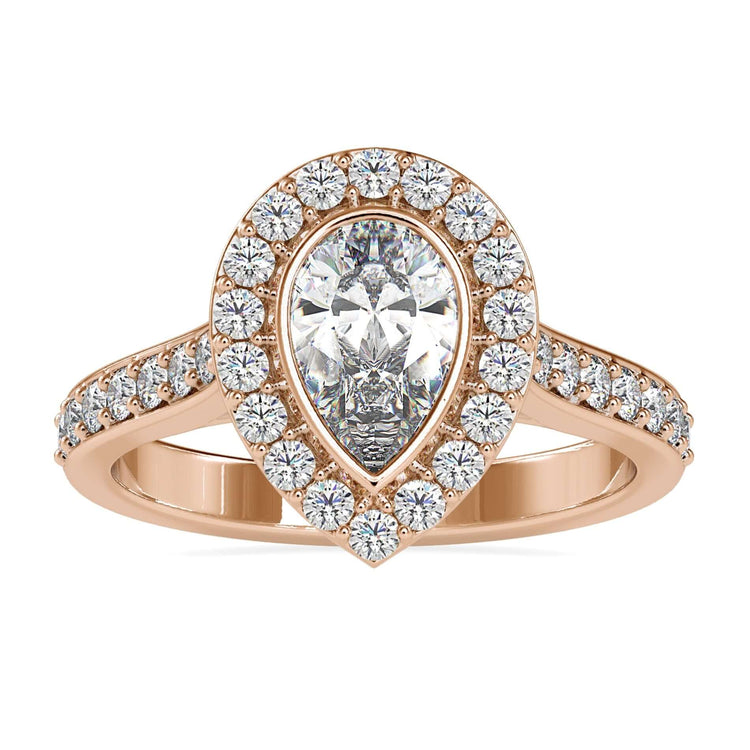 Pear cut engagement ring with bezel set round halo.