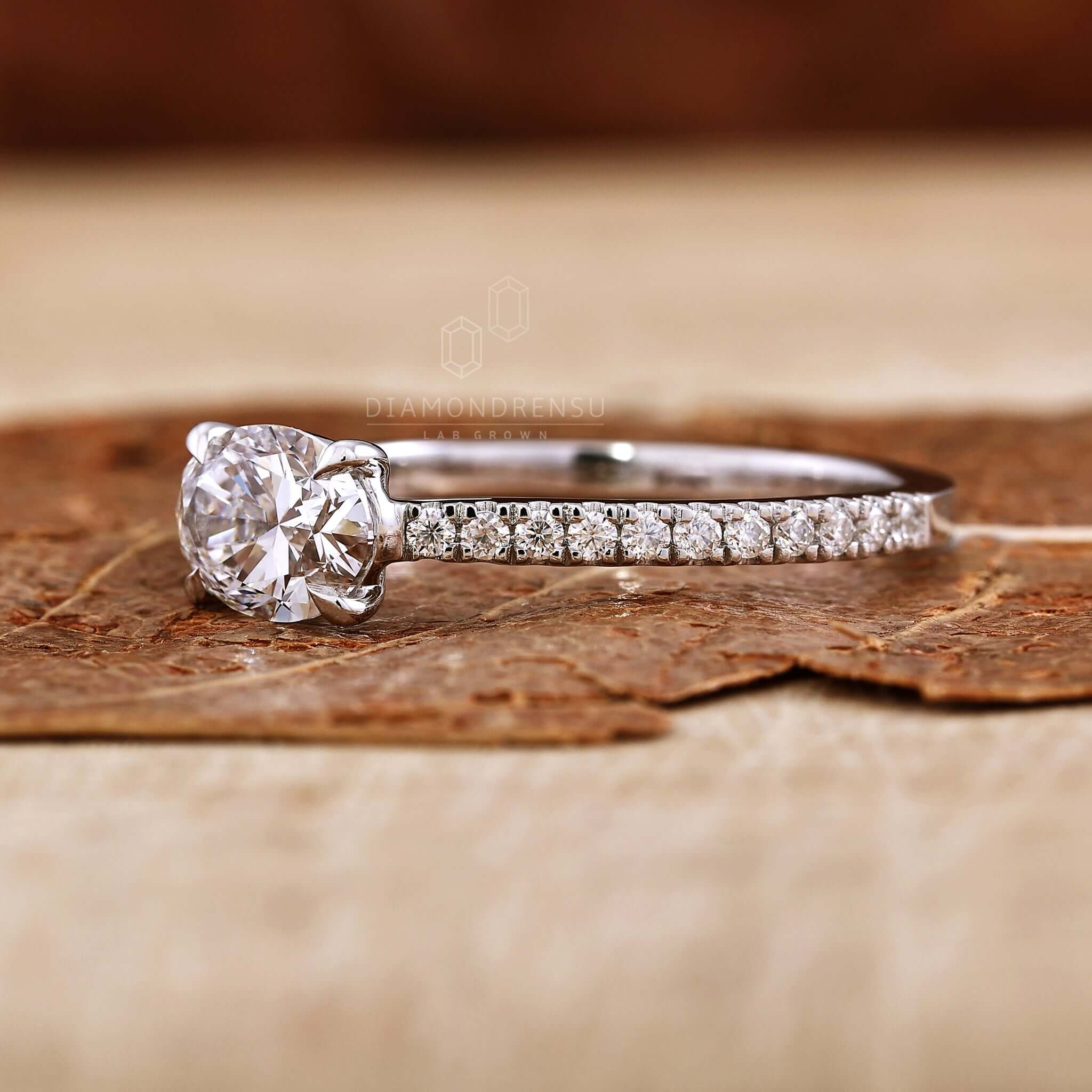 Oval engagement ring with a pave diamond ring accent