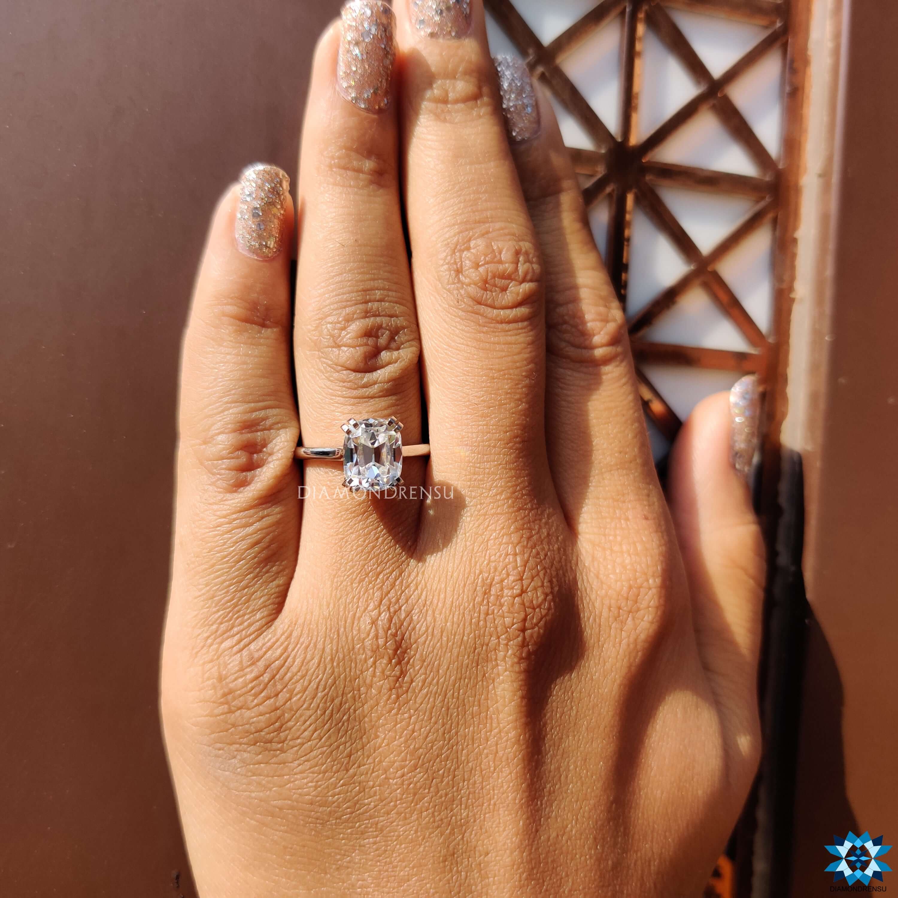 Cushion old European cut ring with double claw prongs.