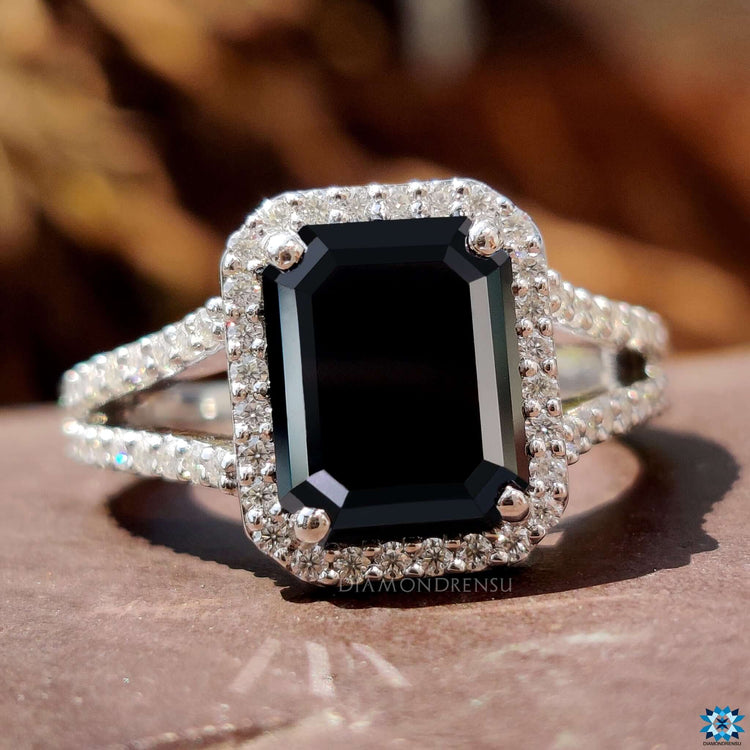 Four prong set emerald cut moissanite ring with round pave band.