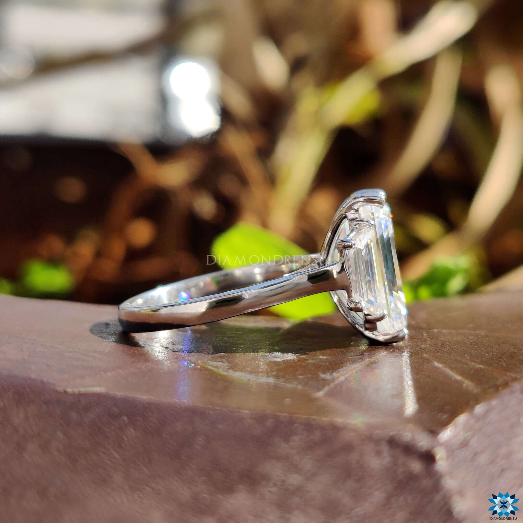 Emerald cut moissanite ring with side stones.