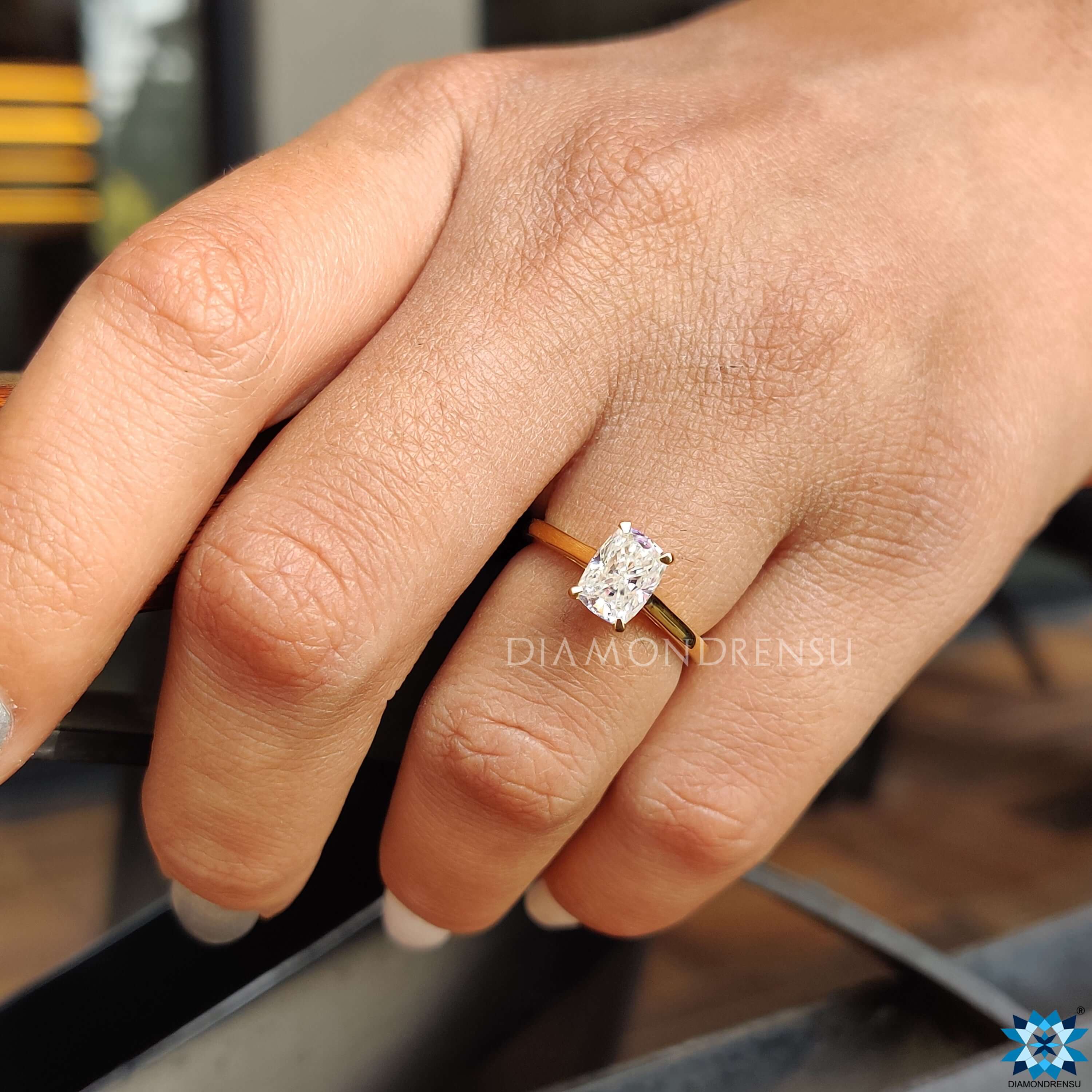 Cushion moissanite ring with elevated cathedral shoulders for extra brilliance.