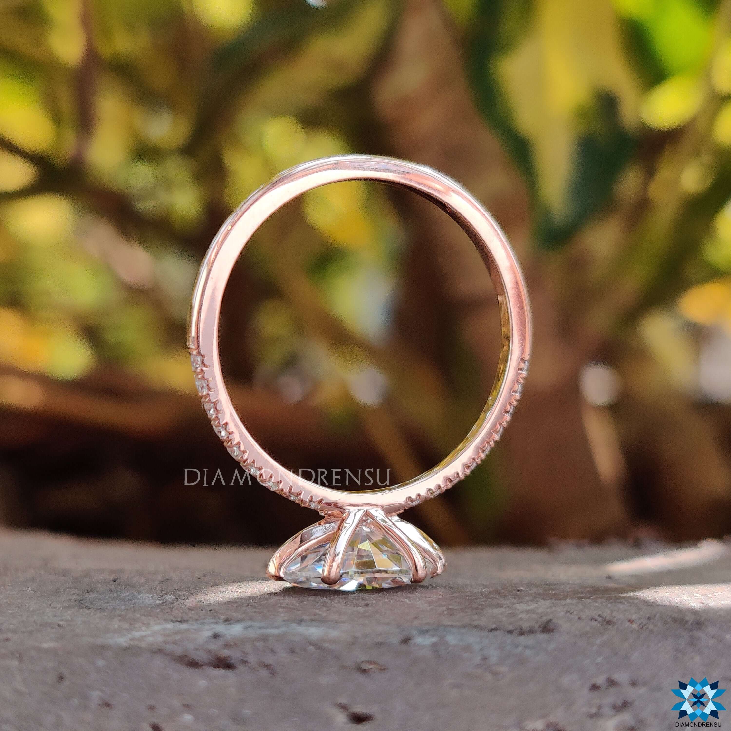 Custom moissanite engagement ring with pave band.