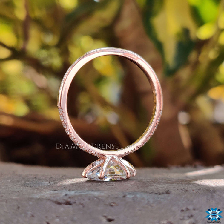 Custom moissanite engagement ring with pave band.