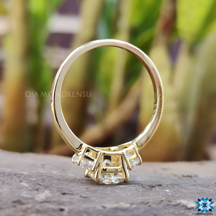 Yellow gold ring with cushion and half moon moissanite.