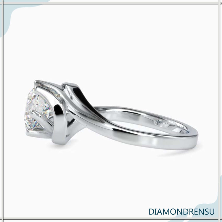 UK engagement ring with round diamond and bypass design.