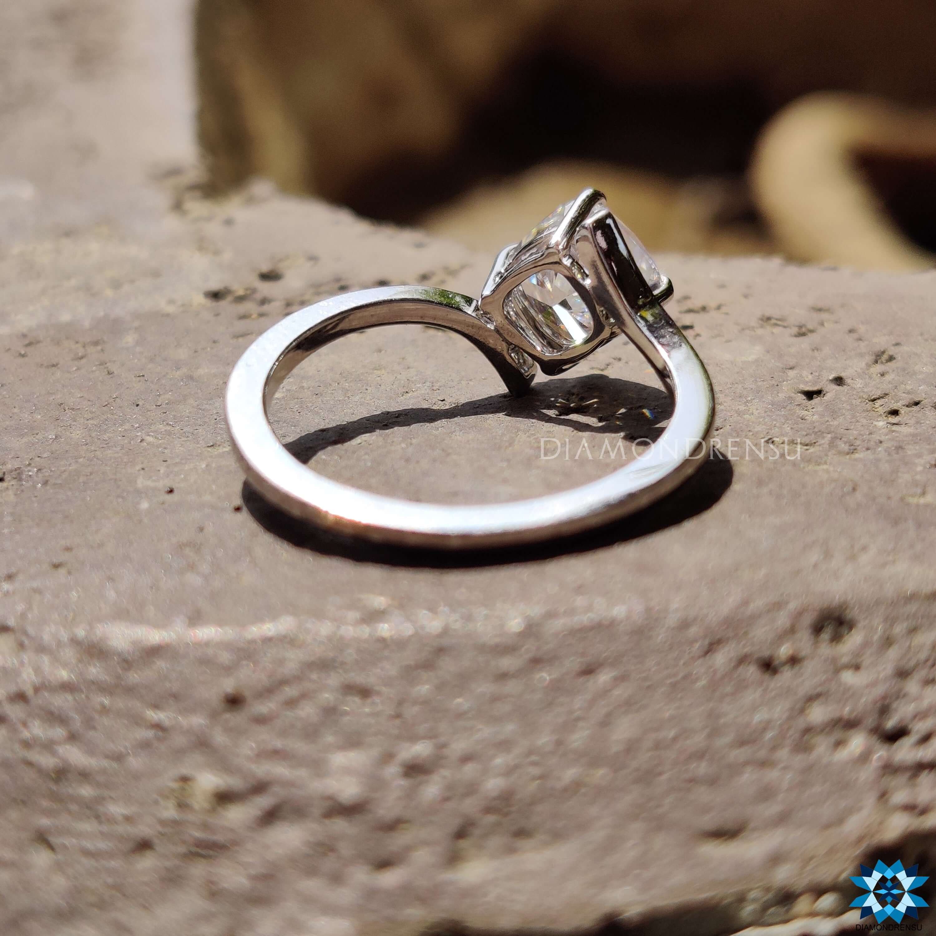 Four prong tension set cushion cut moissanite ring.