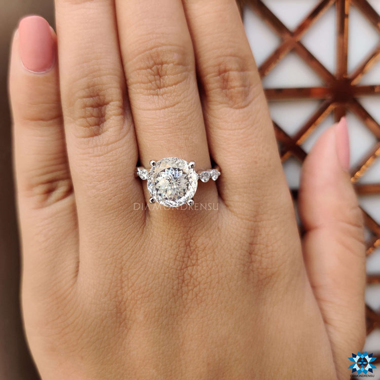 Round side stone ring with a Portuguese cut moissanite in a bubble pave design.
