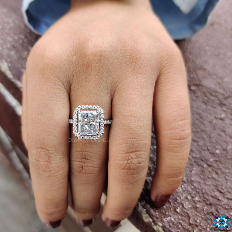 Radiant cut moissanite engagement ring with 3/4 pave detailing.