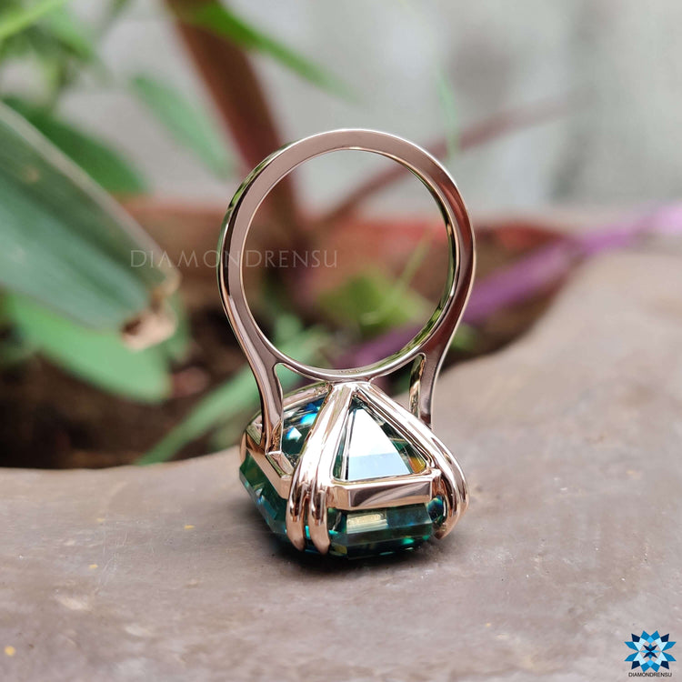 Handmade moissanite ring in rose gold with double claw prongs.