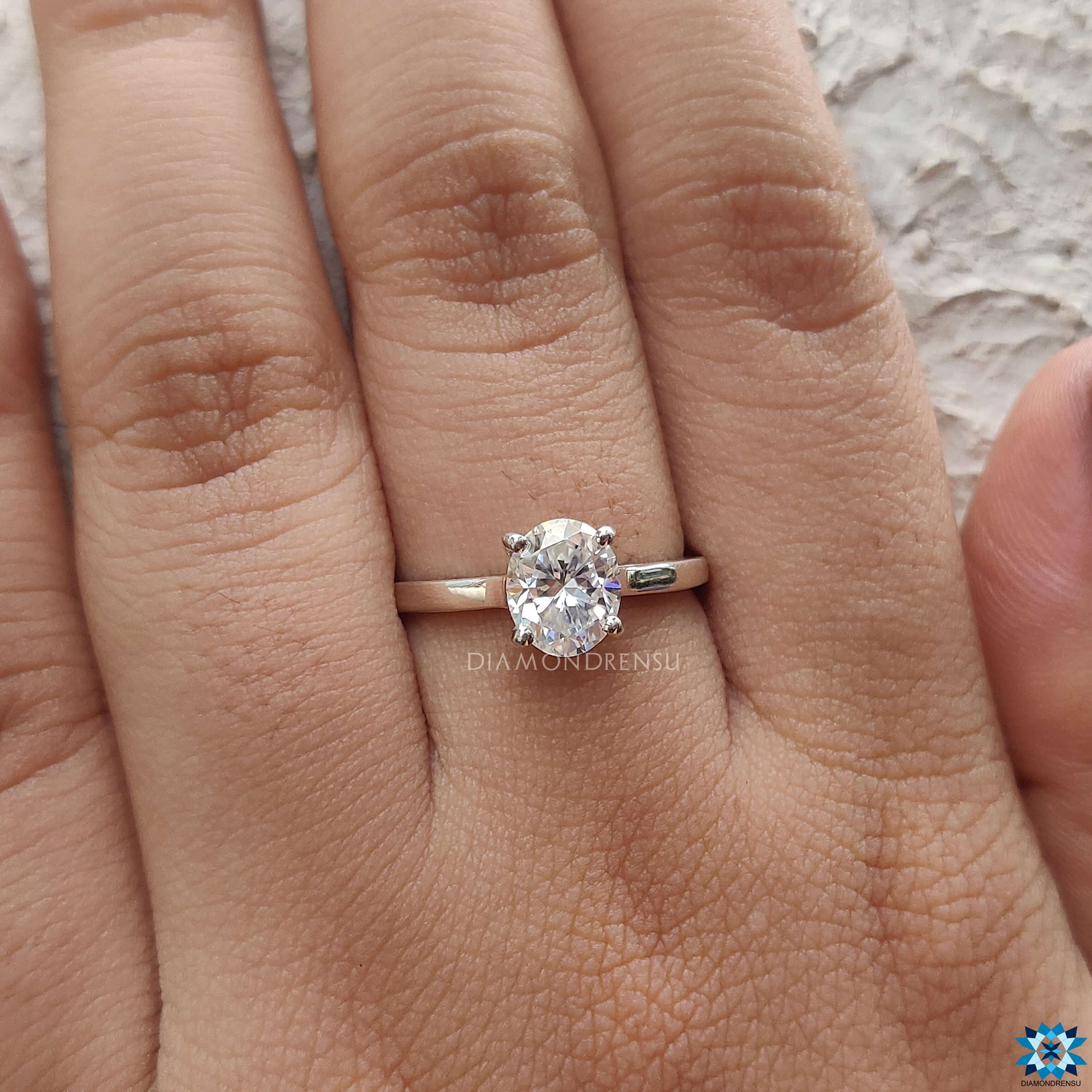 Diamondrensu UK engagement ring in cathedral setting with an oval solitaire moissanite.
