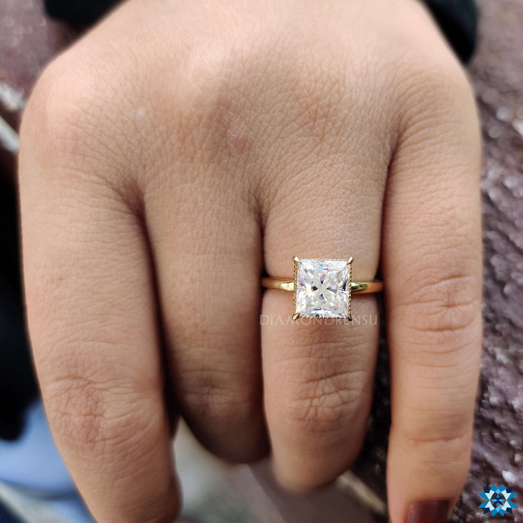 Handmade jewellery showcasing a princess cut moissanite with prong setting.