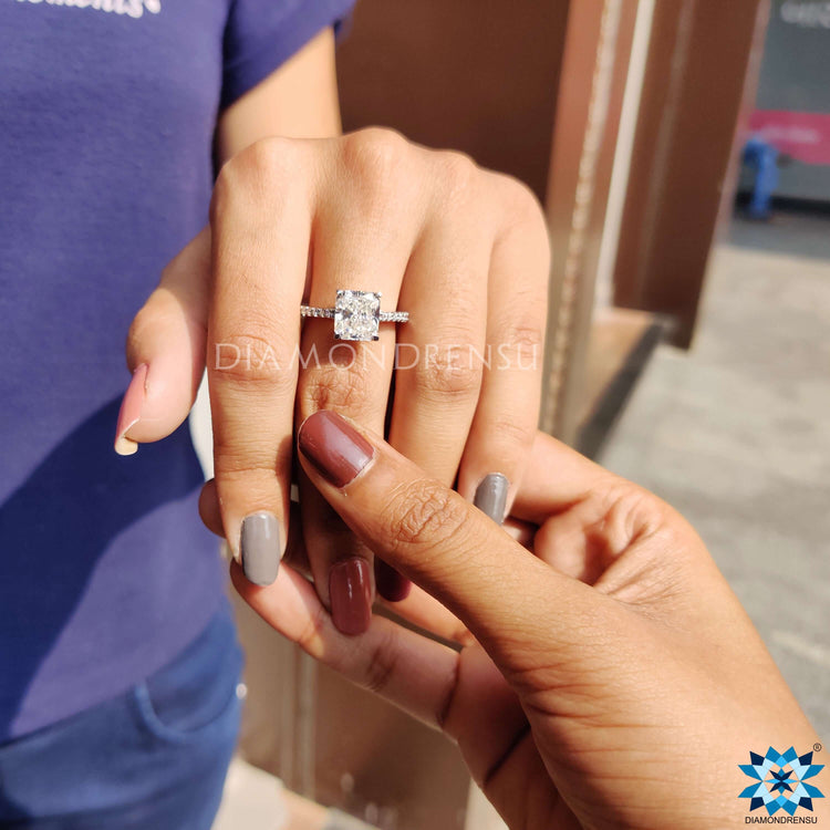 Handmade ring with radiant moissanite and a pave band in white gold.