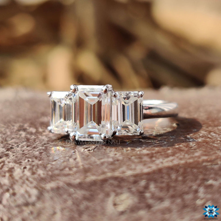 Emerald cut moissanite ring with side stones.