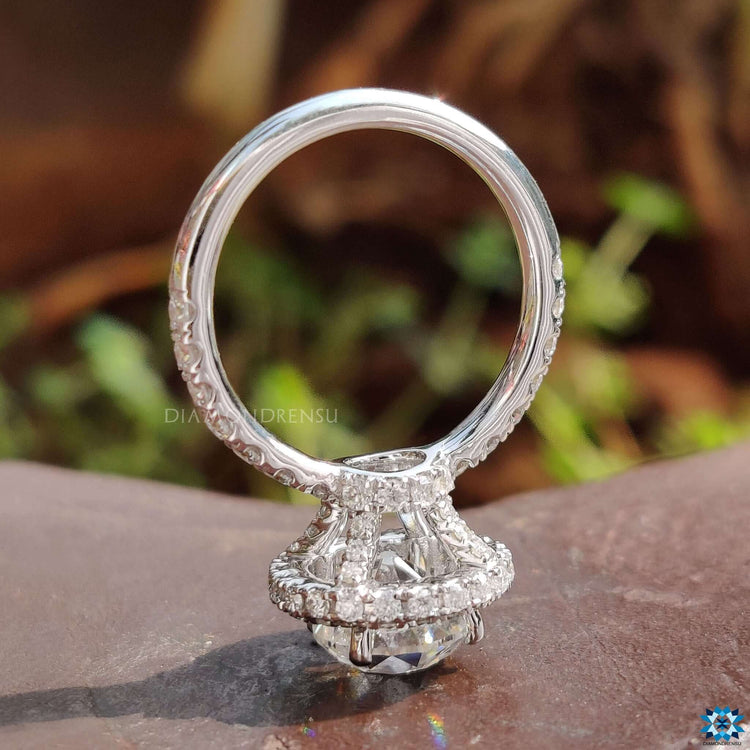 Handmade white gold ring with a two side halo setting.