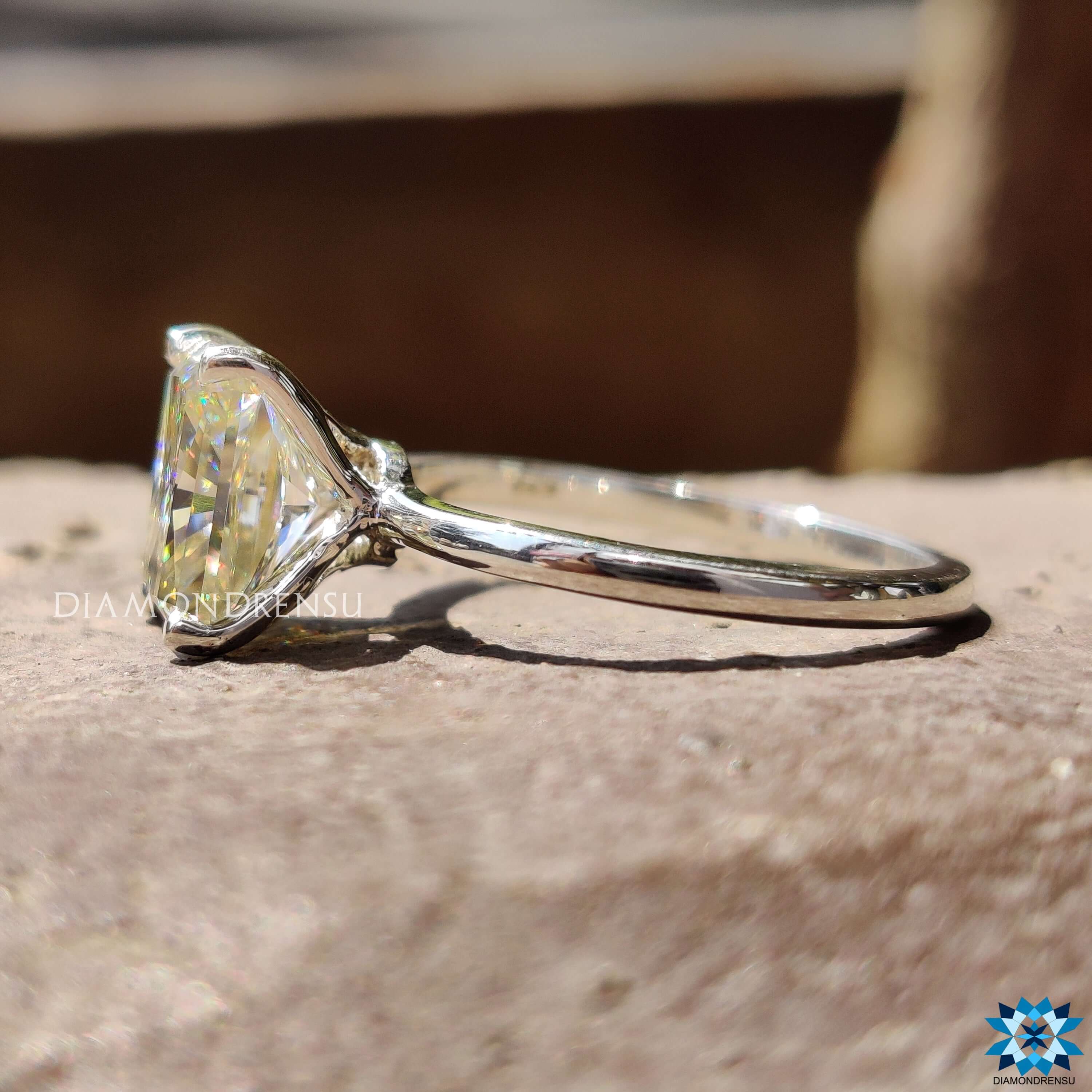 Custom engagement ring featuring light yellow moissanite in classic solitaire design.