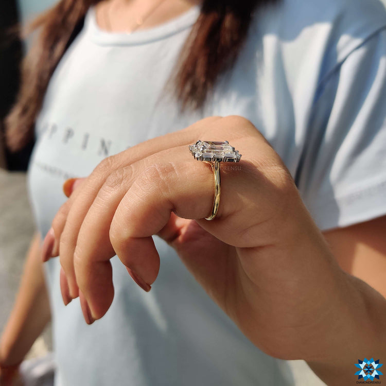 Handmade ring with emerald cut moissanite center.