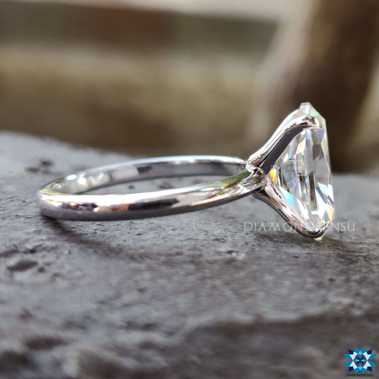 Custom moissanite engagement ring with prong setting.