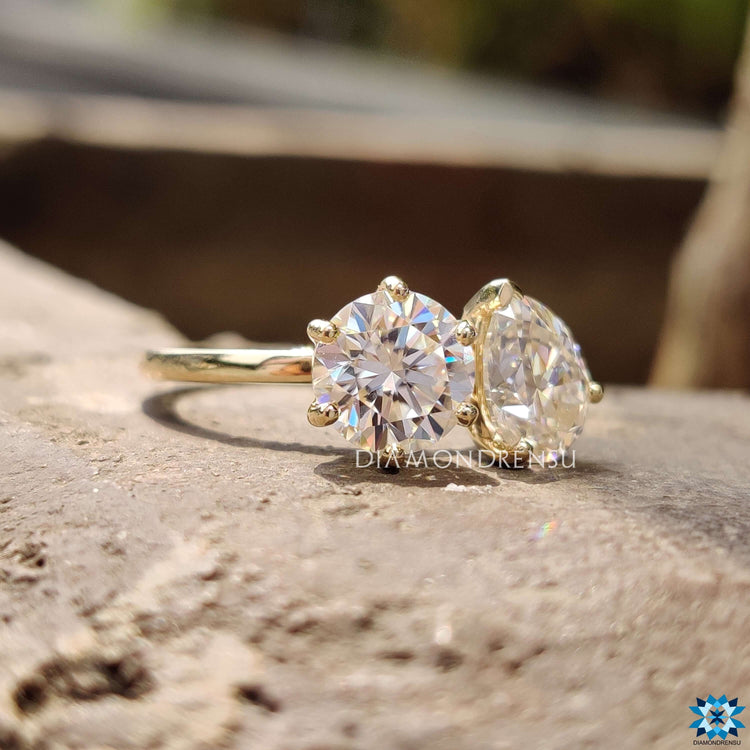 Yellow gold Toi et Moi ring with prong setting.