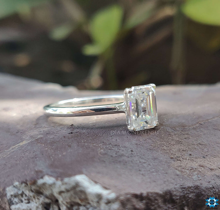 Moissanite solitaire ring featuring a brilliant emerald cut stone for a radiant sparkle.