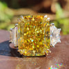 3 stone white gold ring with radiant cut center.