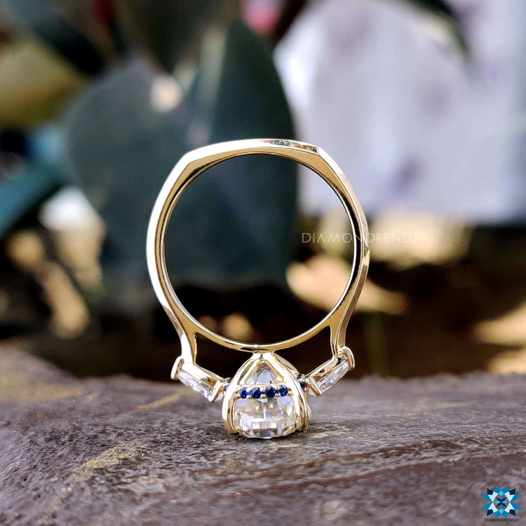 Cathedral setting ring with oval Rensu cut stone.