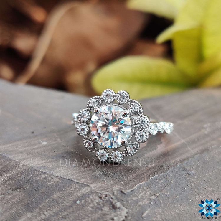 Side stone engagement ring featuring dazzling accents for extra brilliance.