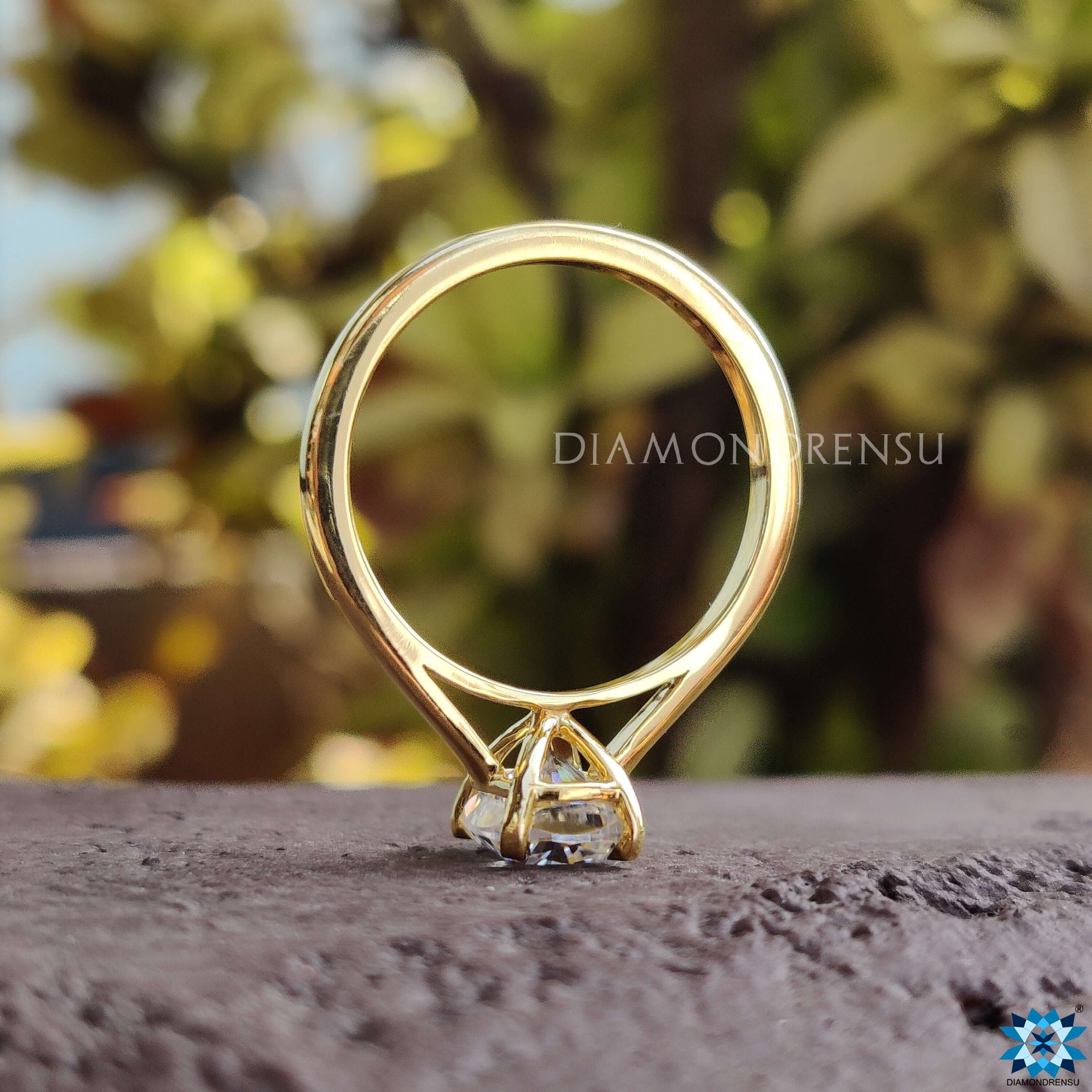 Timeless cushion cut moissanite solitaire crafted in solid yellow gold.