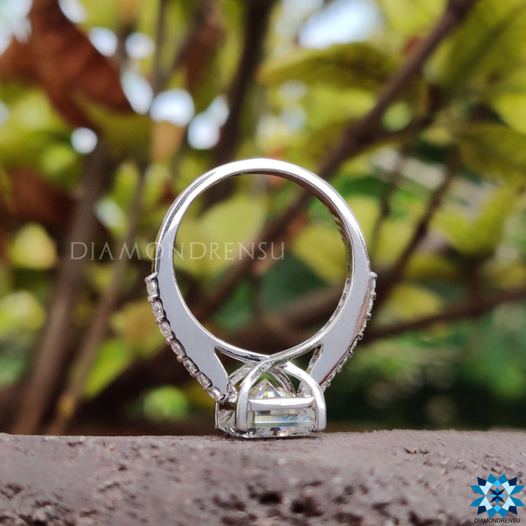 White gold engagement ring with radiant cut moissanite and pave details.