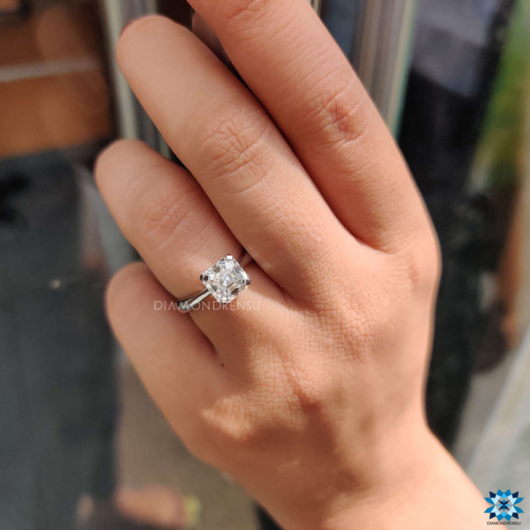 White gold ring with octavia cut moissanite center stone.