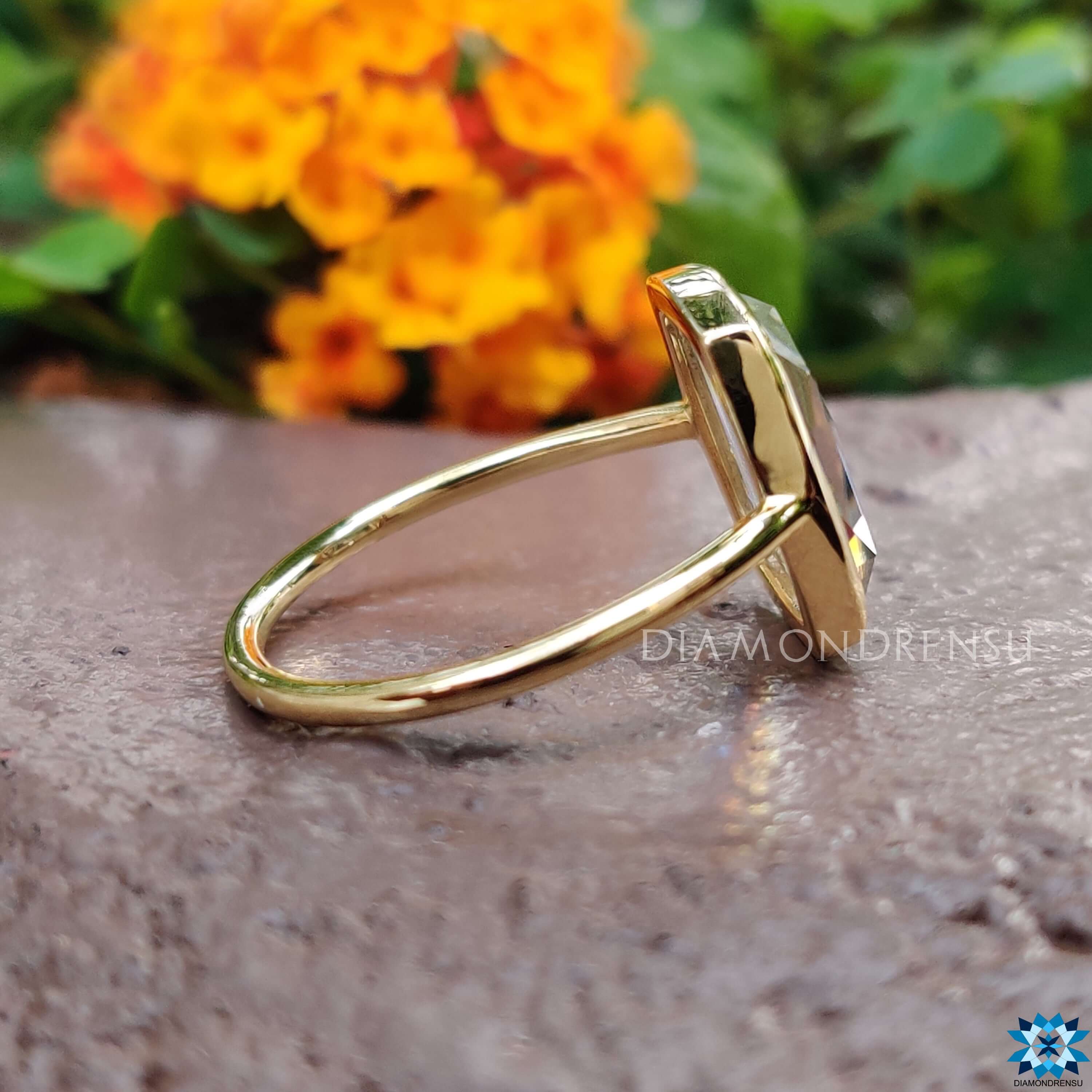 Custom moissanite engagement ring in bezel setting.